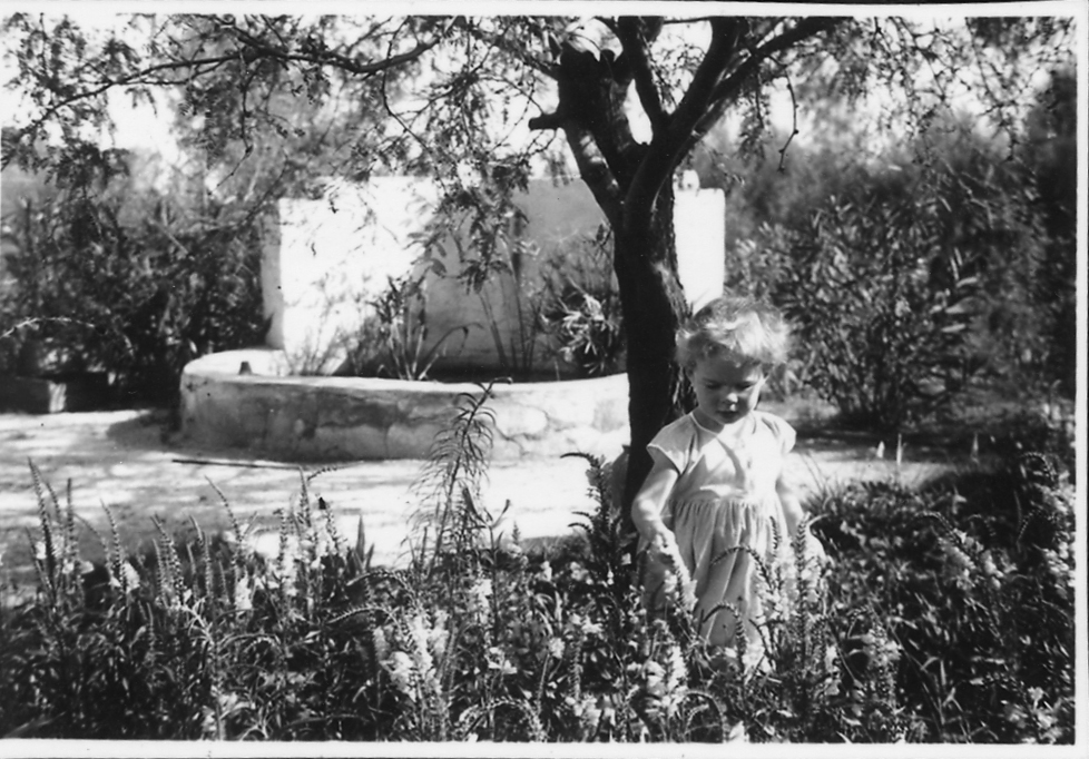 Black and white photograph of a child in the gardens